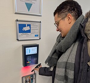 Studentin scannt ihren Bibliotheksausweis zur Identifizierung